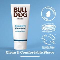 A tube of Sensitive Shave Gel for men stands upright on a blue background, featuring “Fragrance Free,” “Vegan Approved,” and “Cruelty-Free International” labels, plus “Clean & Comfortable Shave” with natural origin ingredients printed below.