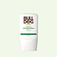 A white bottle of Original After Shave Balm with Aloe Vera, displaying brown and green text. This 100 ml moisturising balm contains natural origin ingredients and comes in Bulldog Skincare packaging with a light background.