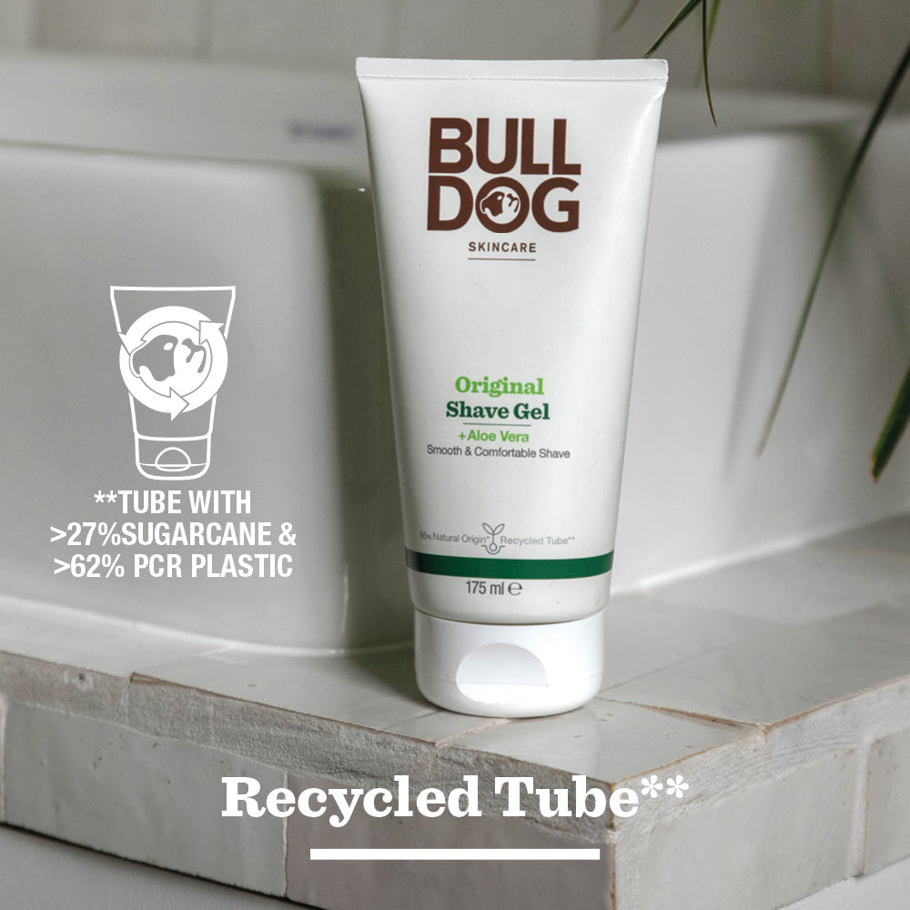A tube of Original Shave Gel for men sits on the bathroom counter. The text notes its natural origin ingredients like aloe vera and a tube made from over 27% sugarcane and 62% recycled plastic.