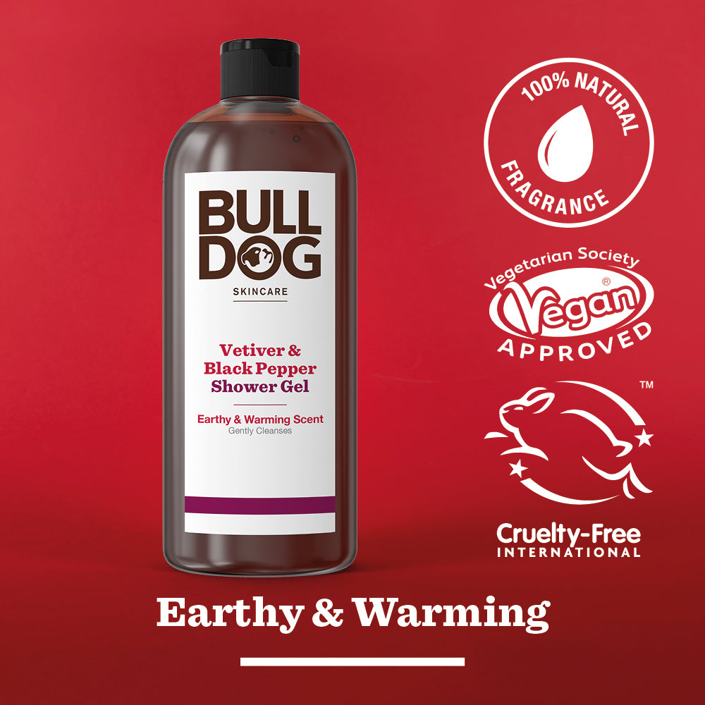 A bottle of Vetiver & Black Pepper Shower Gel stands against a red background, showcasing its 100% natural fragrance and vegan approval—perfect for men seeking an earthy, warming touch in their skincare routine.