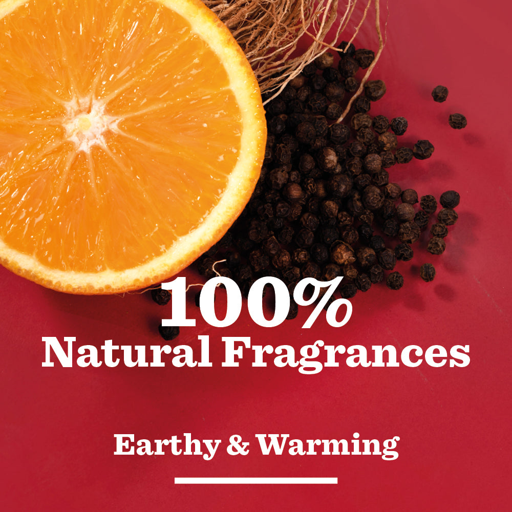 A halved orange, black peppercorns, and a coconut shell on red with 100% Natural Fragrances—an earthy, warming blend in Vetiver & Black Pepper Shower Gel, perfect for natural shower gel or men’s skincare.