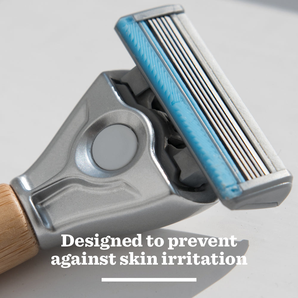 Close-up of Sensitive Steel Blades Razor with a blue strip and wooden handle, featuring tempered steel blades and text: Designed to prevent against skin irritation.