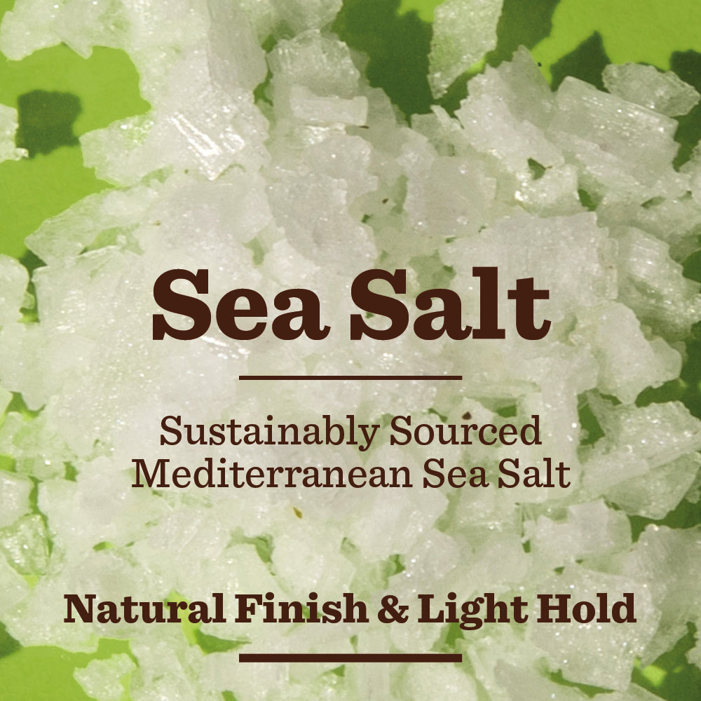 Close-up of coarse white Mediterranean sea salt crystals on a green surface with text: Sustainably Sourced Mediterranean Sea Salt, Naturally Derived & Light Hold—perfect for Bulldog Original Hair Styling Salt Spray.