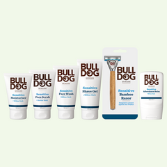 Six Bulldog Skincare products, including the Bamboo Razor and items from the Sensitive Skin Bundle Collection, are lined up in their packaging against a plain light background.