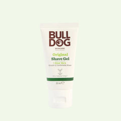 A tube of Original Shave Gel Mini 30ml, made with natural ingredients and aloe vera, stands upright on a light, plain background. The packaging features a white and green label.