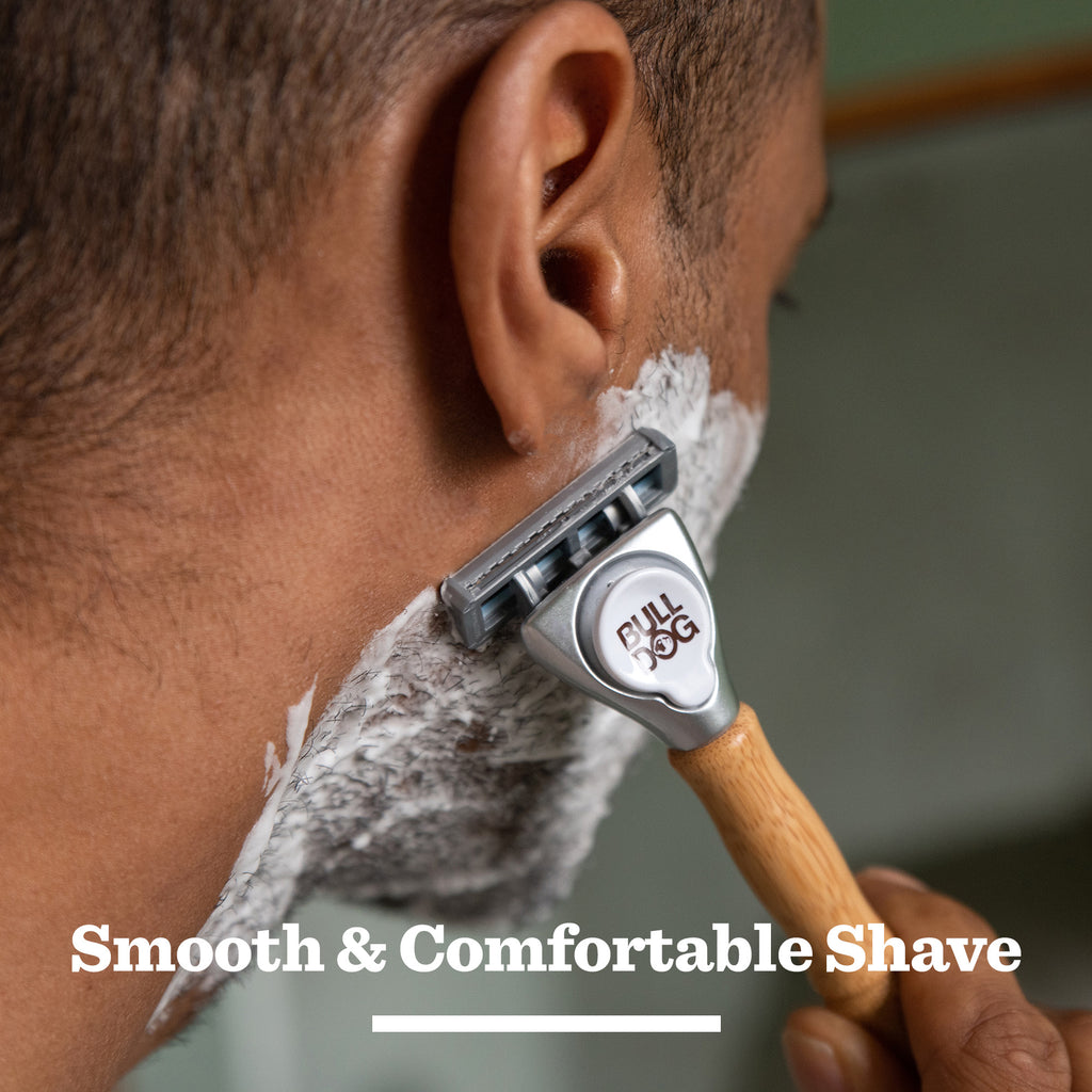 A close-up of a person shaving their face with the Original Shave Duo razor, gliding it over shave gel on their jawline. The text below reads: Smooth & Comfortable Shave.