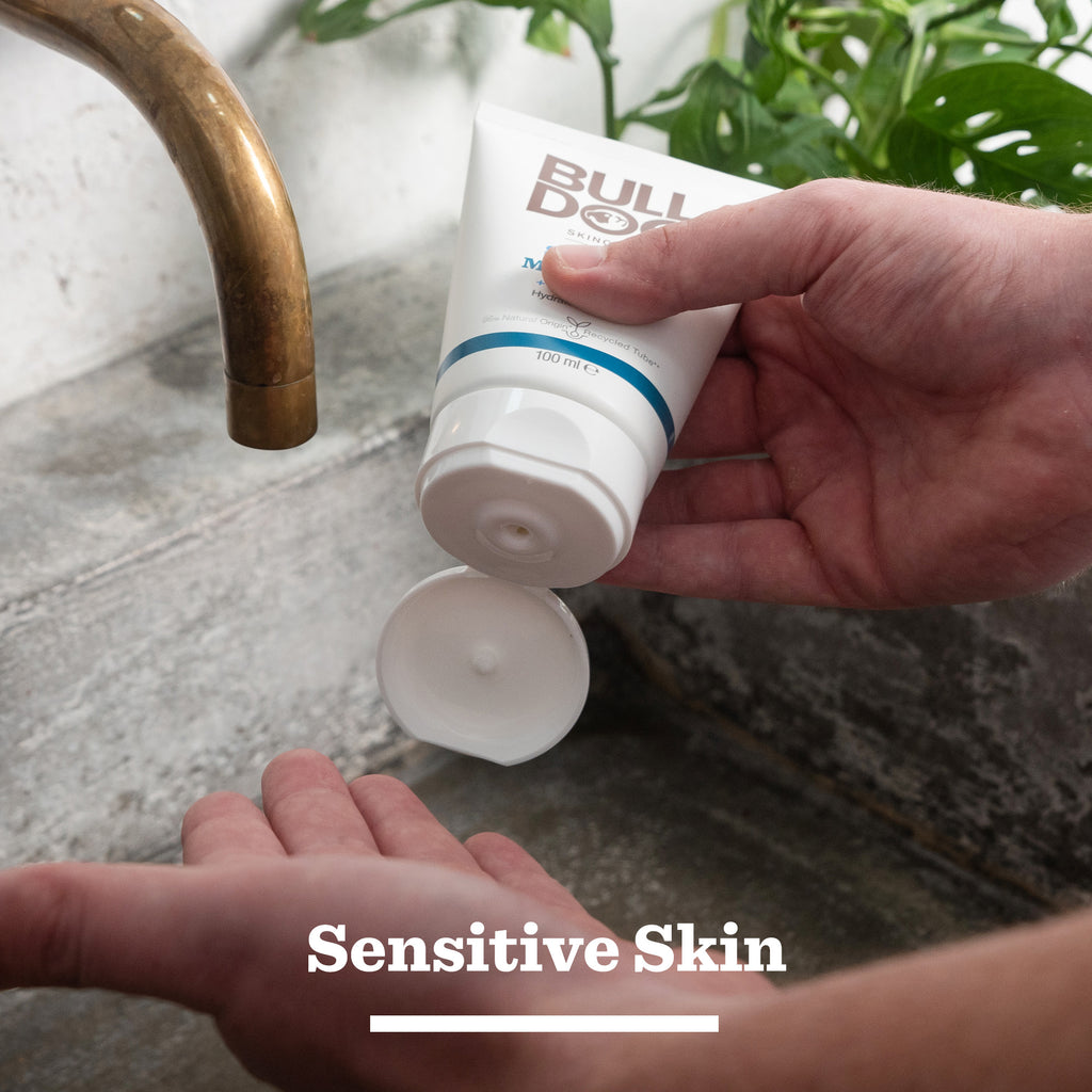 A person dispenses Sensitive Skincare Duo onto their hand by a sink with green leaves behind. "Sensitive Skin" appears below, highlighting it as an ideal gift for men.