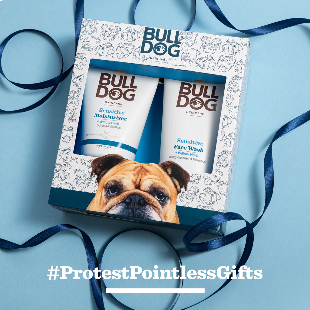 The Sensitive Skincare Duo gift set for men includes a Sensitive Moisturiser and face wash in a decorative box tied with a navy ribbon. "#ProtestPointlessGifts" appears at the bottom.