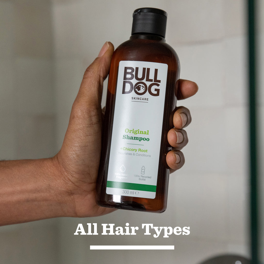 A hand holds a bottle of Hair Styling Trio. Perfect for men's hair care, the label mentions it nourishes and conditions, and the phrase All Hair Types appears at the bottom of the image.