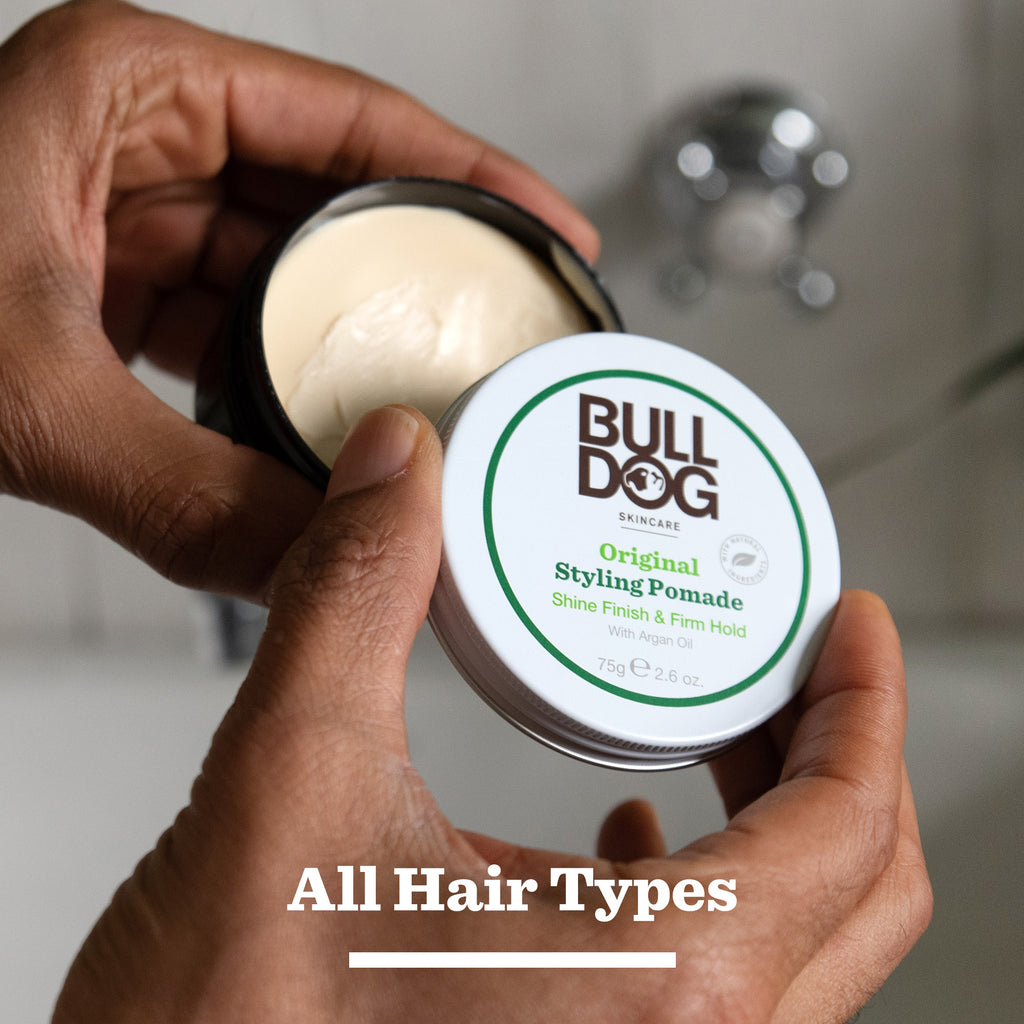 A person holds an open tin from the Hair Styling Trio, revealing creamy product inside—perfect for men's hair care. Text below the tin reads All Hair Types.