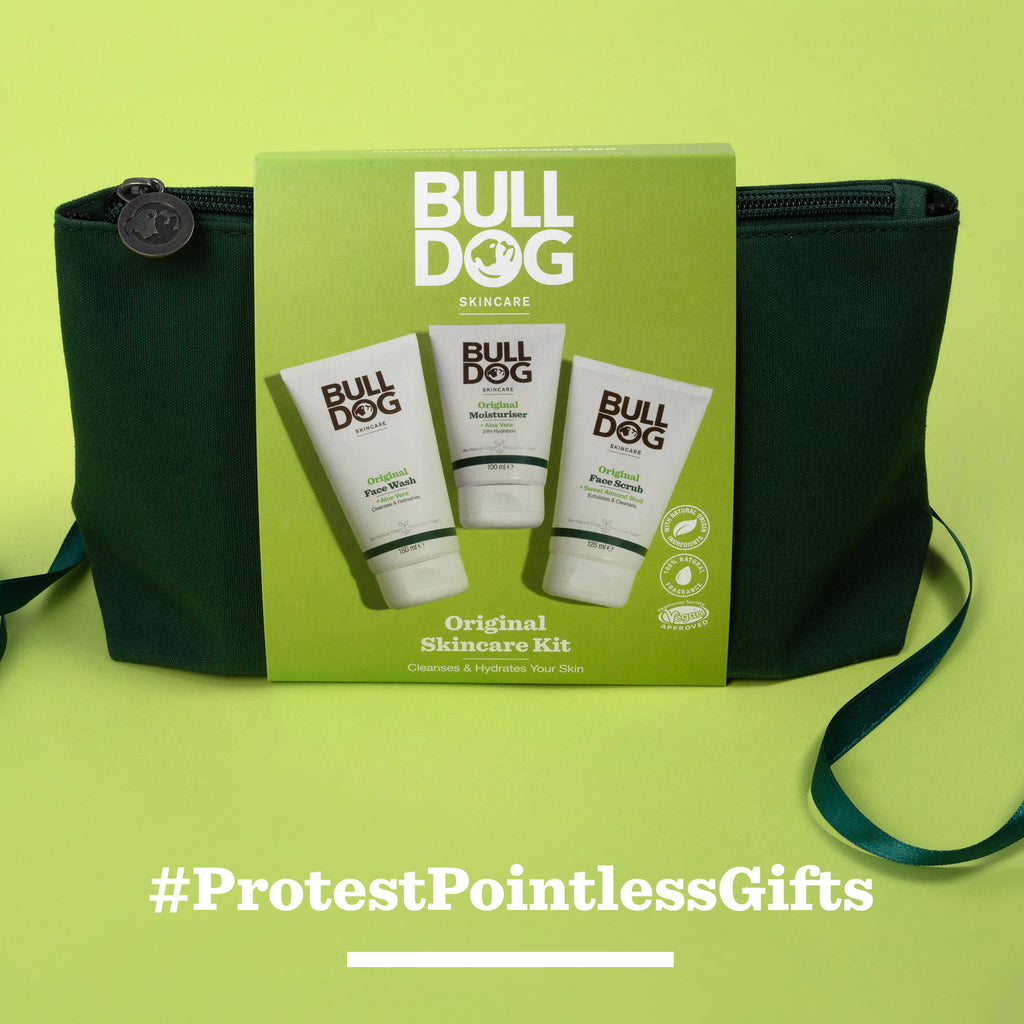 A Bulldog Original Skincare Kit with three tubes is set before a dark green pouch on a light green background—perfect for men’s gifting. Below, the text reads #ProtestPointlessGifts.