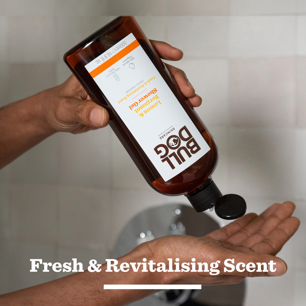 A person pours Lemon & Bergamot Body Care Duo shower gel into their hand, bottle upside down over a sink. Text reads: Fresh & Revitalising Scent—ideal as thoughtful gifts for men.