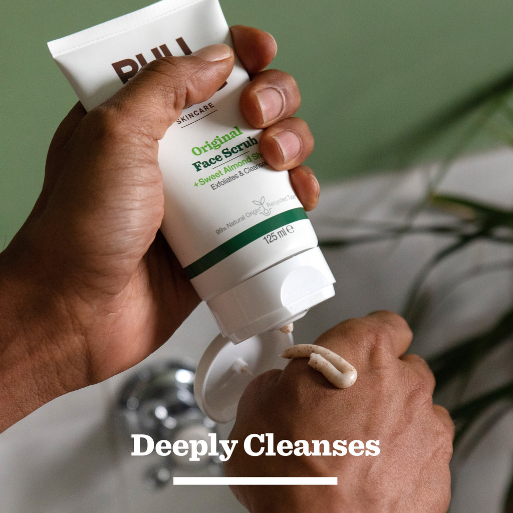 A person squeezes Bulldog Skincare’s Original Skincare Duo Set onto their hand from a white tube, with “Deeply Cleanses” below—an ideal gift for men seeking a fresh face before applying Original Moisturiser.