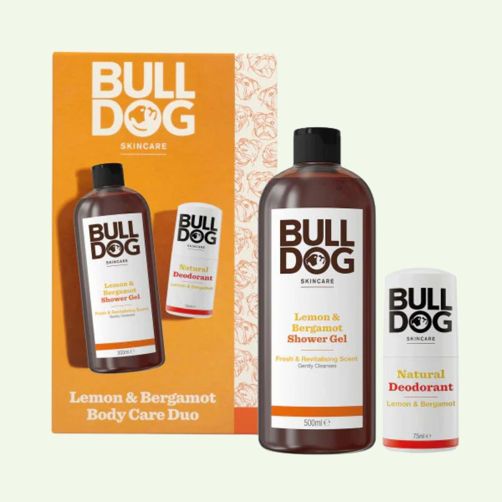 The Lemon & Bergamot Body Care Duo is displayed in front of bold orange and yellow packaging—ideal for men who enjoy fresh, invigorating body care products.